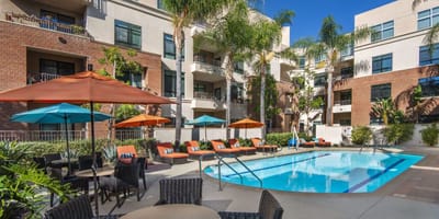Outdoor pool area with lounge chairs and umbrellas