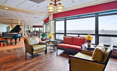 Bright common area with comfortable seating and piano
