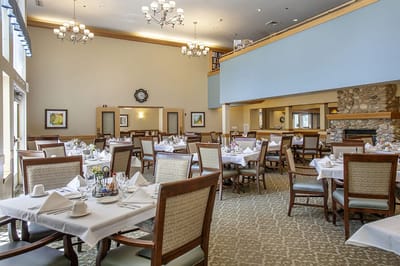 Bright dining area with tables set for residents
