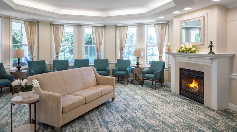 Bright common area with seating and a fireplace