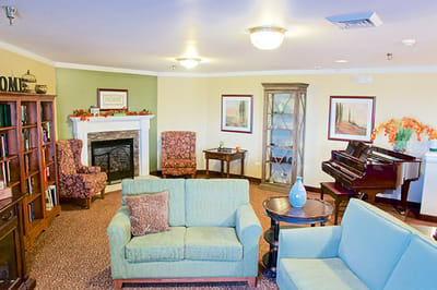 A cozy common area with seating and piano