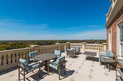 Outdoor patio area with seating overlooking a landscape