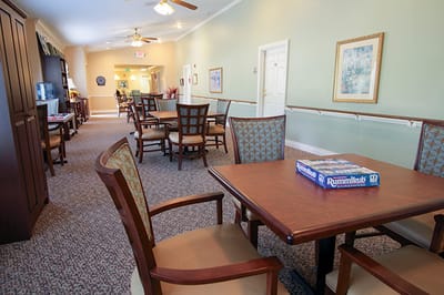 Interior view of a common area with seating and game table