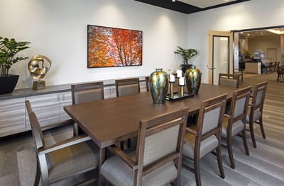 Dining room with a large wooden table and decorative vases