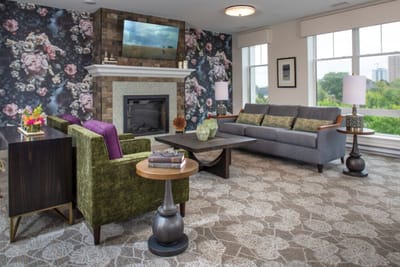 Cozy lounge area with floral wallpaper and comfortable seating
