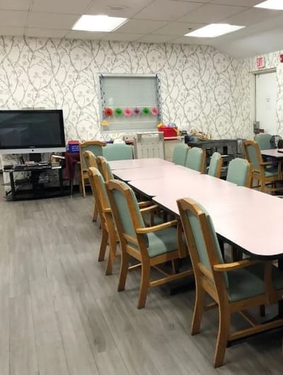Common area with tables and chairs in a light setting