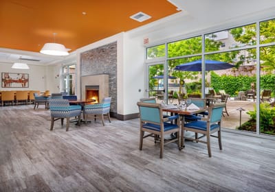 Interior common area with dining tables and view of garden