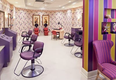 A colorful beauty salon with chairs and decor