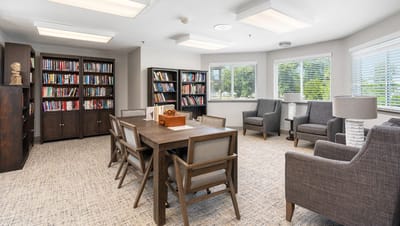 A cozy interior reading room with bookshelves and seating