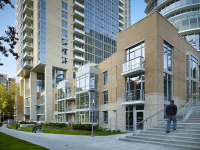 Exterior view of a senior living facility with steps and greenery