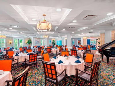 Bright and inviting dining room with tables set for meals