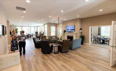 Residents and staff socializing in a bright common area