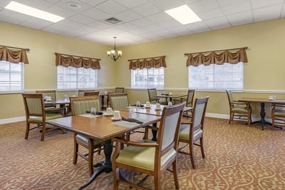Bright dining room with multiple tables and chairs