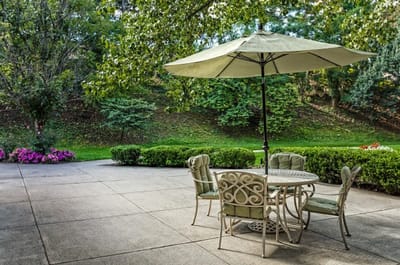 Outdoor patio area with a table and umbrella