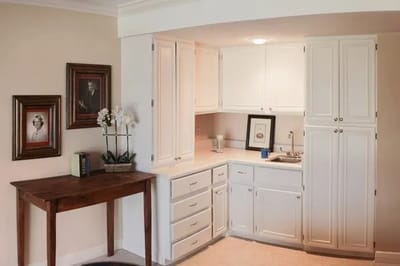 Bright interior of a residential room with a kitchenette