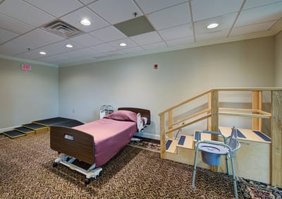 Interior view of a rehabilitation room with a bed