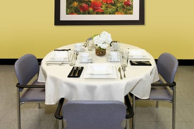 Dining table set for a meal in a bright room