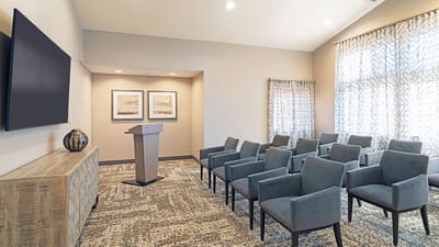 Bright activity room with seating and a podium