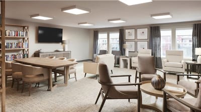 Bright common area with seating and bookshelves