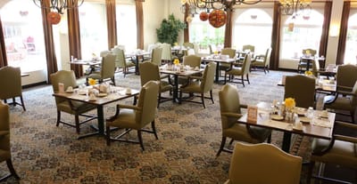 Dining area with tables and chairs set for meals