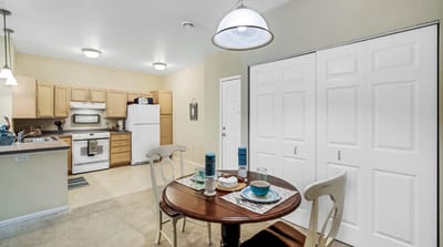 A cozy dining area in a senior living facility apartment