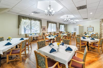 Bright dining room with tables set for a meal