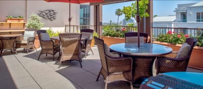 Outdoor patio area with seating and greenery