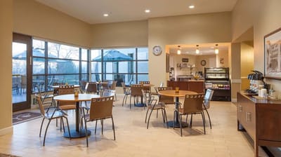 Bright dining room with tables and outdoor views