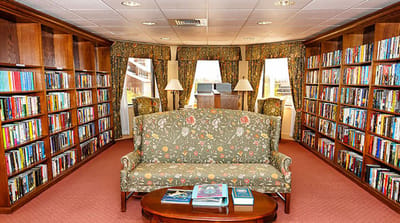 A cozy library area with bookshelves and seating