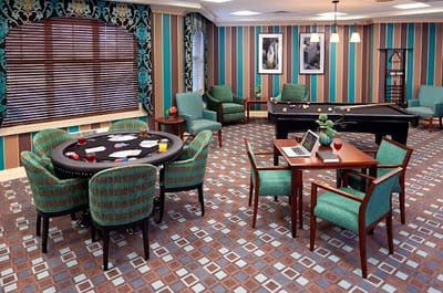 Bright activity room with card table and pool table