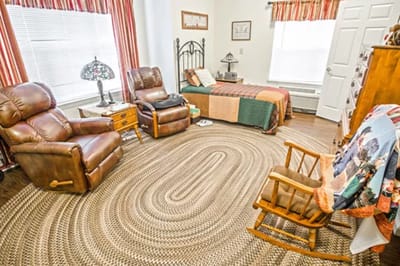 Cozy resident room with seating and bedding
