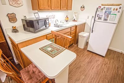 Bright kitchen area with wooden cabinets and appliances