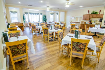 Bright dining room with tables set for meals