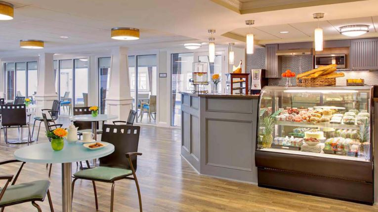 Cafeteria with food display and seating area