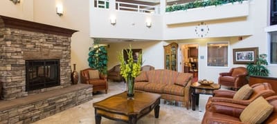 Bright lobby area with seating and a fireplace