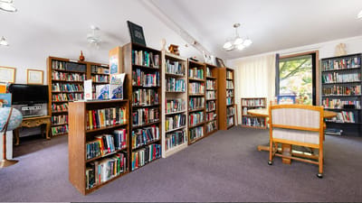 Interior view of the facility library with bookshelves