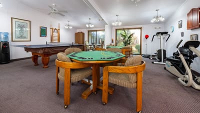 Common area with a pool table and exercise equipment