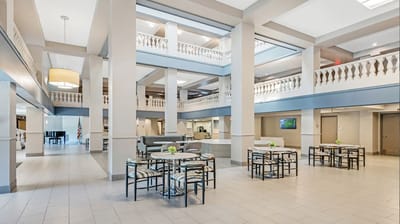 Bright common area with seating and piano