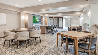 Bright common area with seating and entertainment features