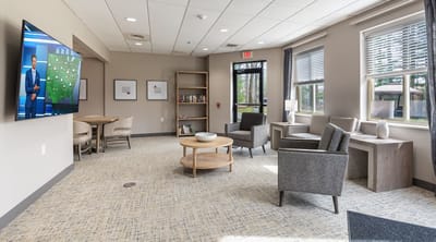 Bright common area with seating and a television