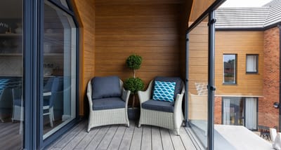 Cozy balcony space with seating and greenery