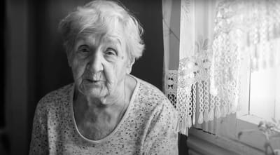 Older woman sitting by a window