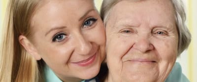 Smiling staff member with a senior resident