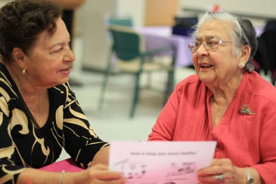 Two senior women engaged in conversation