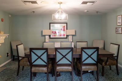 Dining room with a large table and ambient lighting
