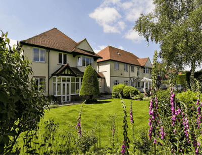 Exterior view of Digby Manor with garden and flowers
