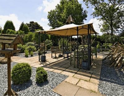 Outdoor seating area with a gazebo and greenery