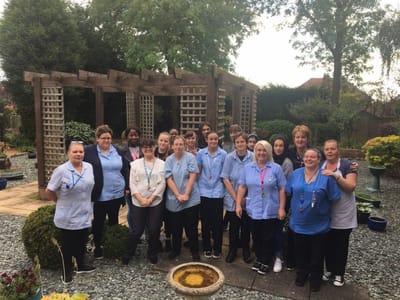 Staff members posing in the garden area