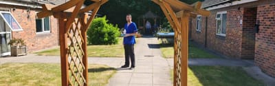 Outdoor space with a staff member and residents