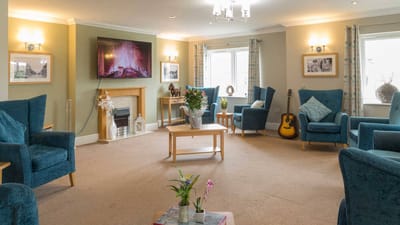 Bright common area with seating and a TV